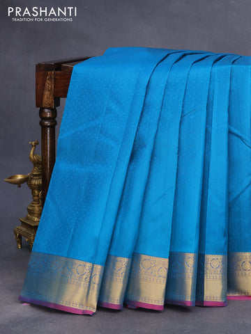 Pure kanchipuram silk saree peacock blue and dual shade of bluish pink with allover self emboss and zari woven border