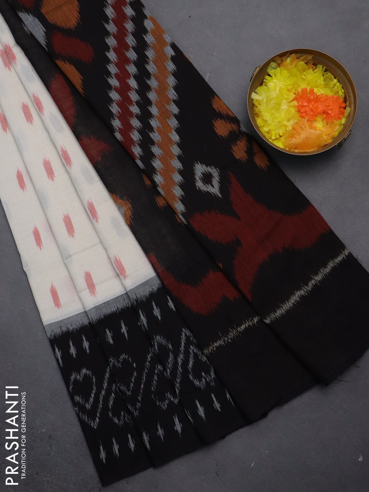Ikat cotton saree off white and black with allover ikat butta weaves and long ikat style border