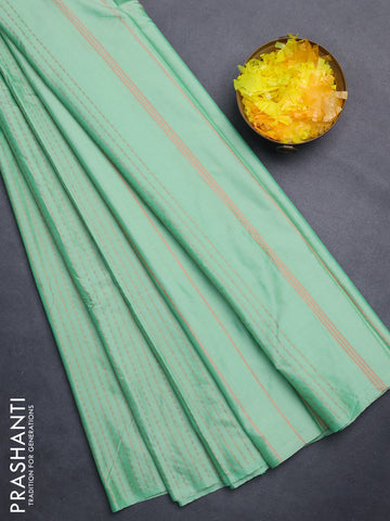 Arani semi silk saree pastel green with allover copper zari weaves in borderless style