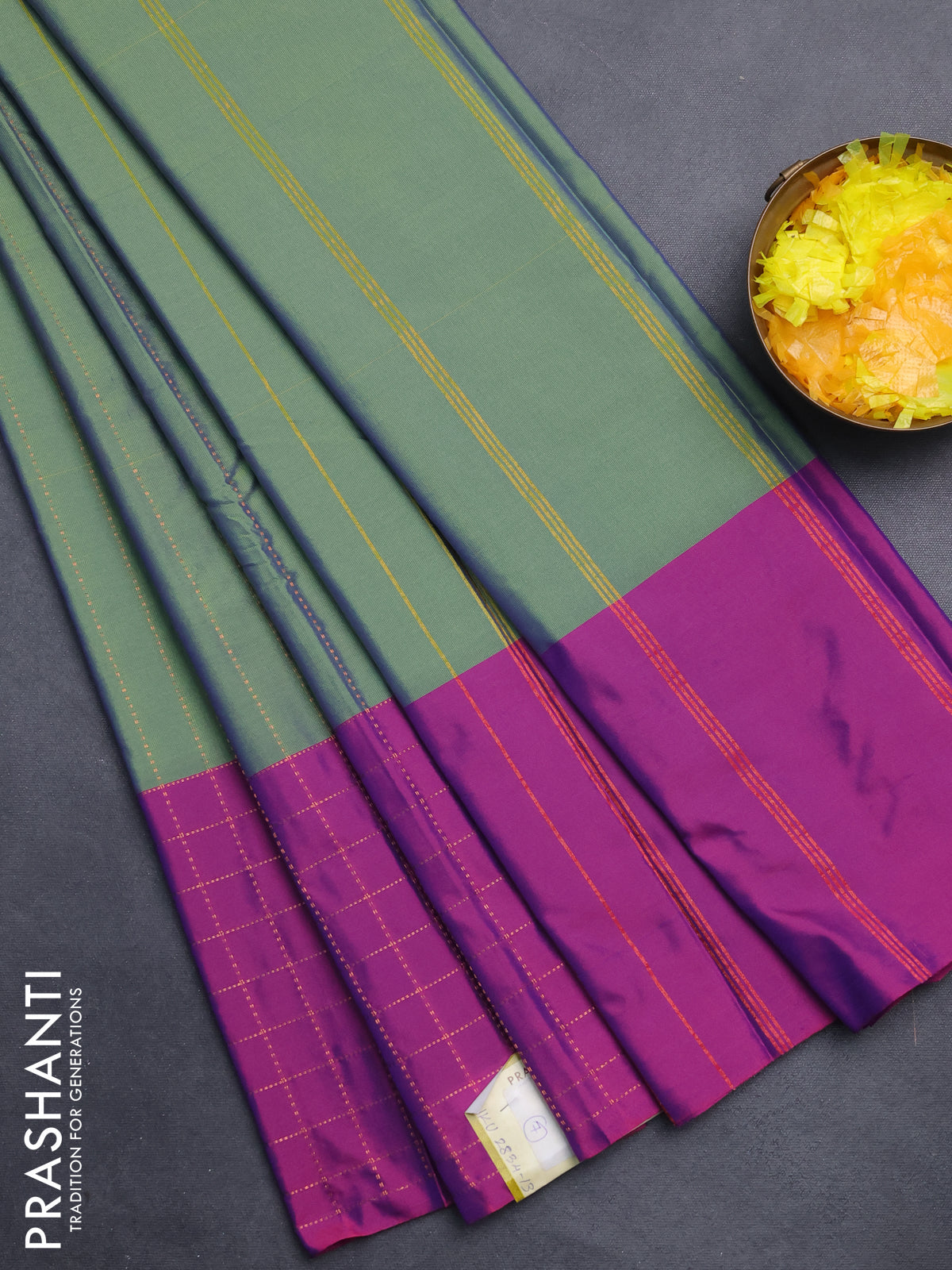 Arani semi silk saree dual shade of green and purple with allover copper zari weaves and zari checked border
